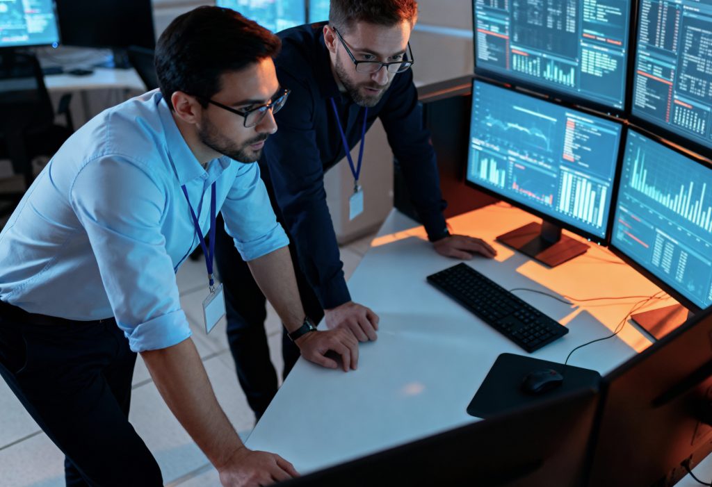 it professionals analyzing real time data control room